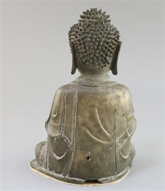 A Chinese bronze seated figure of Buddha Shakyamuni, 17th century, H. 25cm, small losses